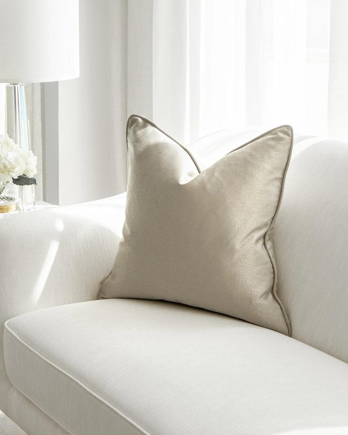 Celeste Laurent cushion in gold and beige, shown in a lifestyle front view as image 1