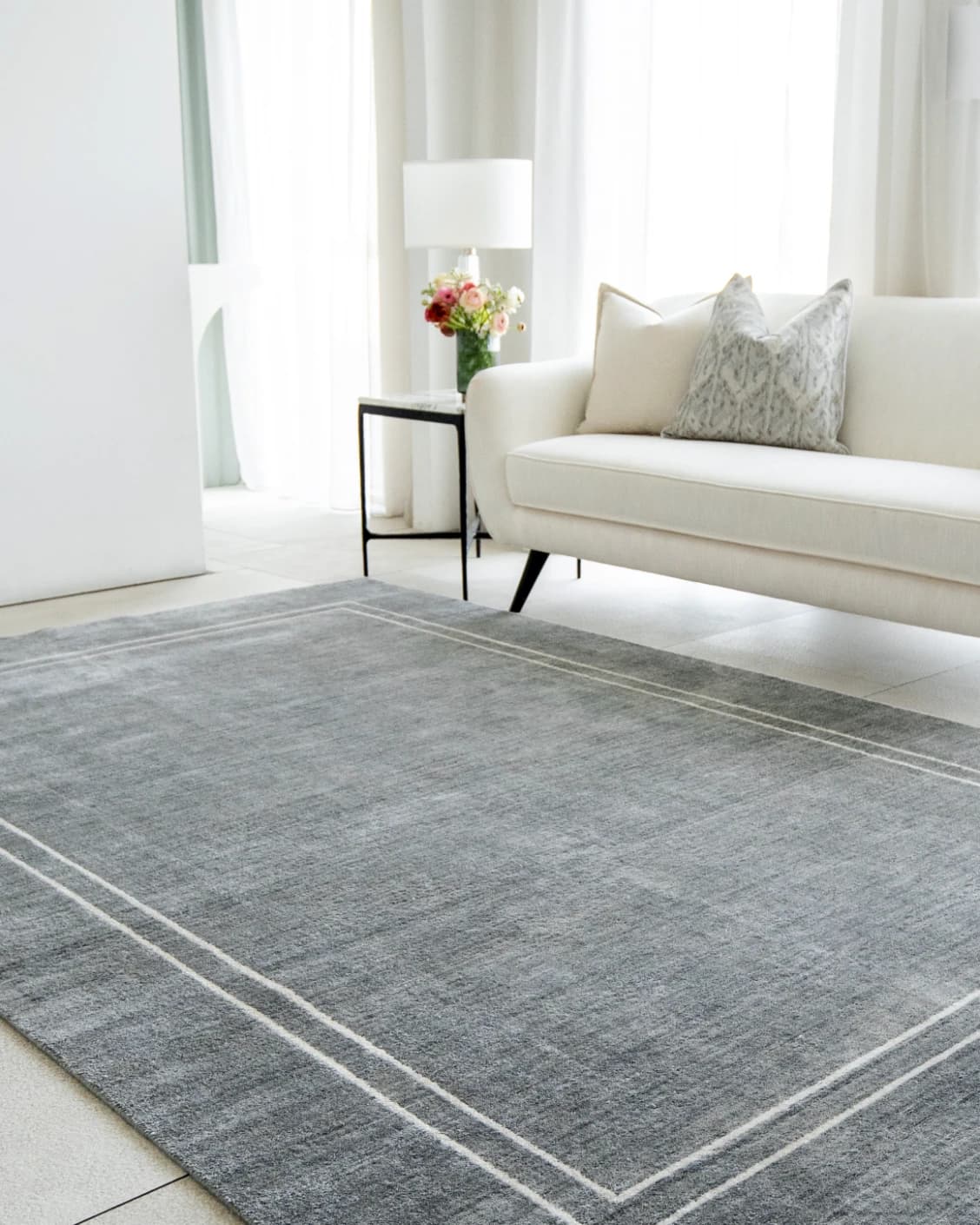 Colin Ashton carpet in blue and white, shown in a lifestyle right view as image 5