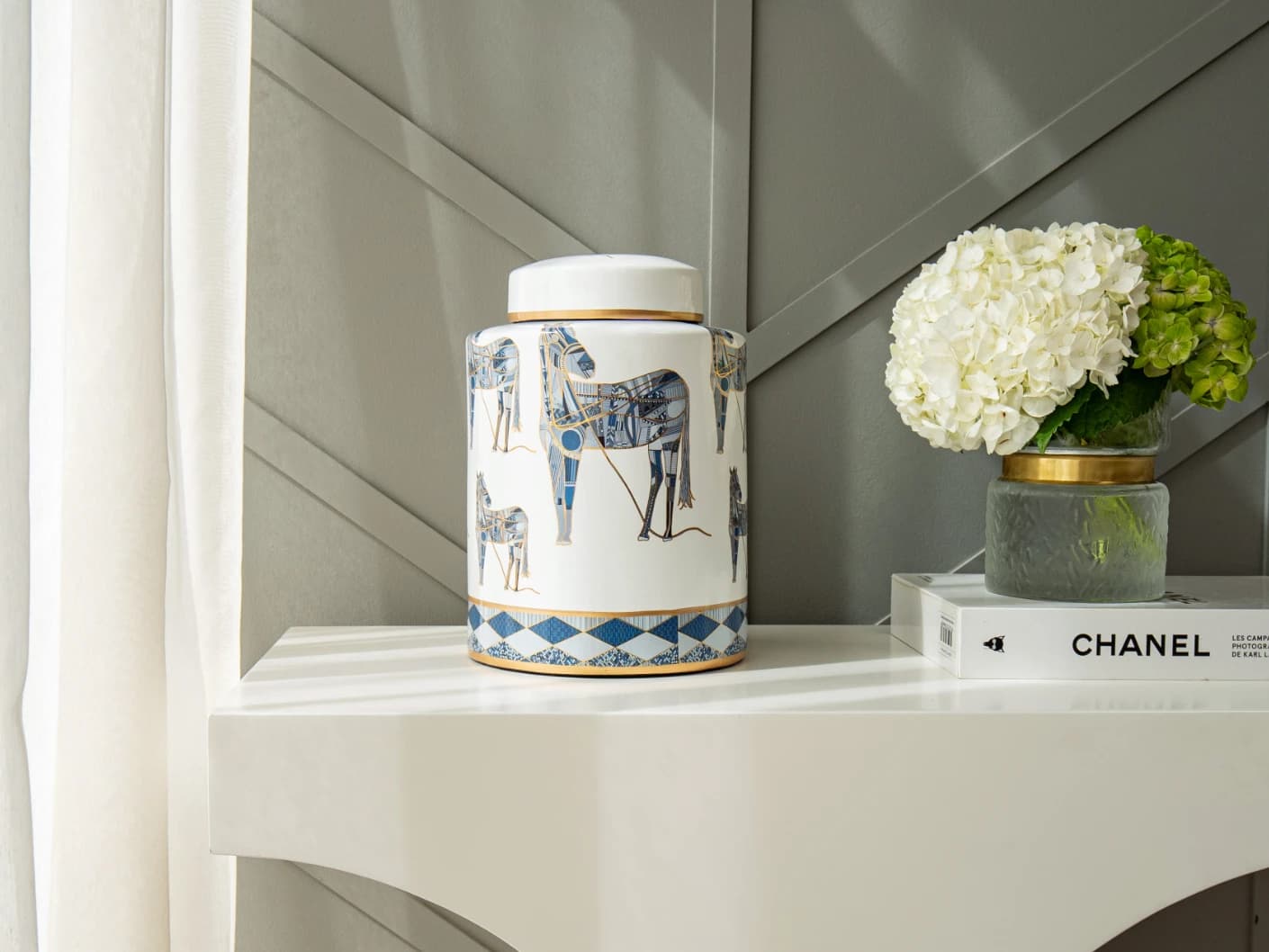 Eloisa Arneson II jars in white and blue, shown in a lifestyle front view