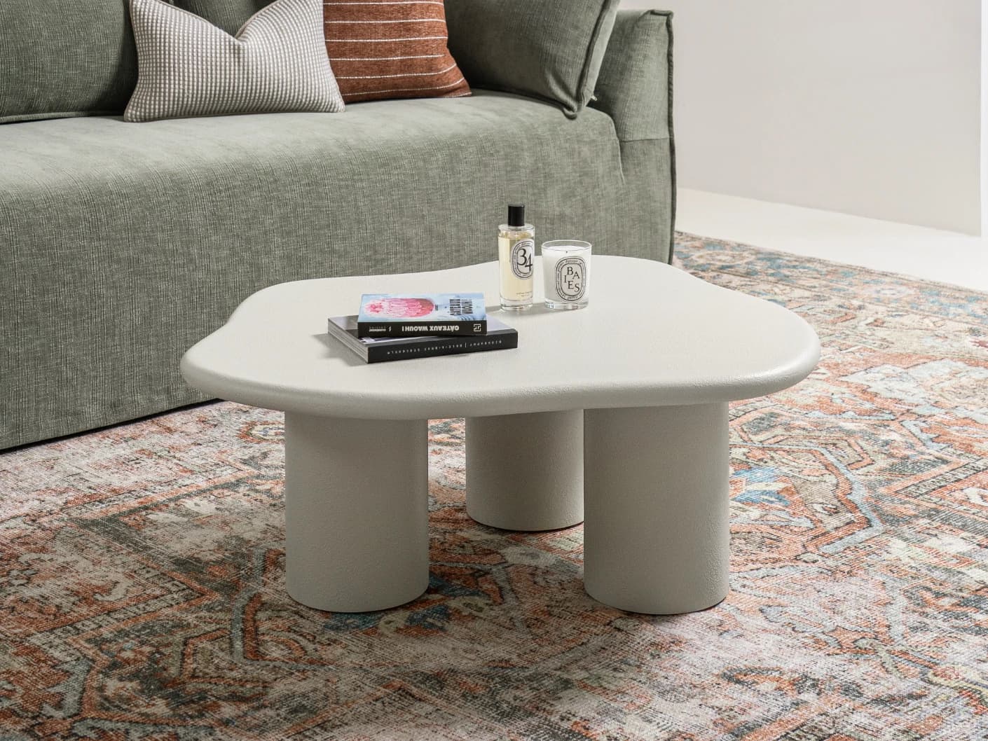 Pienza coffee table in soft ivory and stone, shown in a lifestyle left view